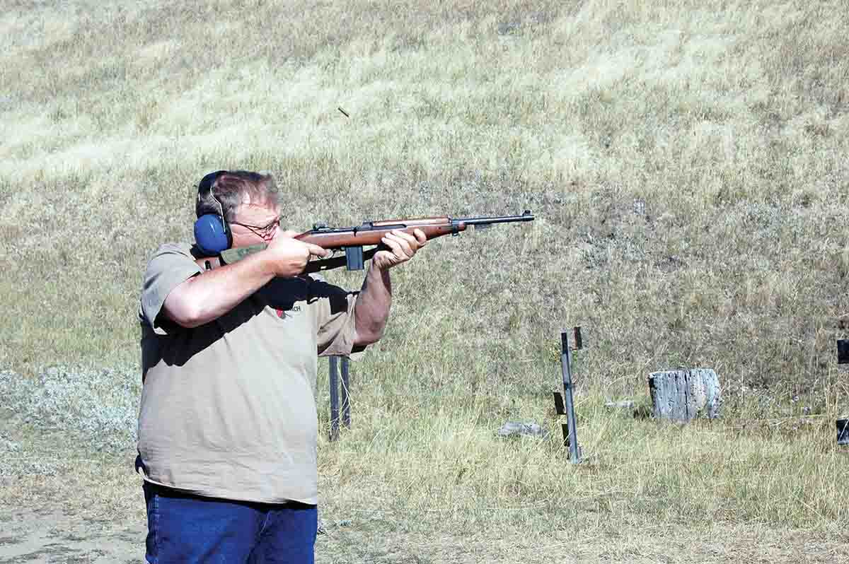 Mike is firing a U.S. M2 Carbine.